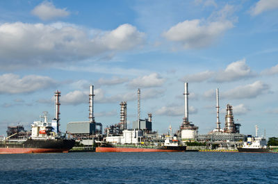 Commercial dock by sea against sky