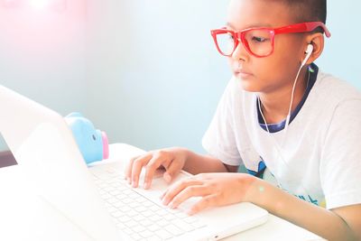 Close-up of boy using laptop