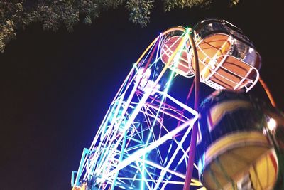 Low angle view of illuminated ferris wheel at night