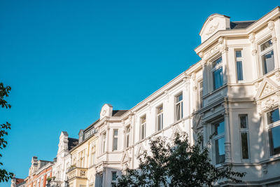 Low angle view of building against clear blue sky