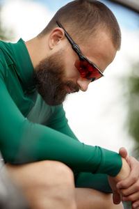 Side view of young man using mobile phone