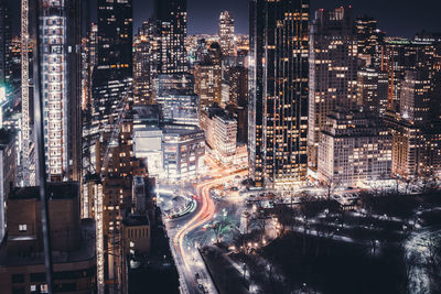 Aerial view of city lit up at night