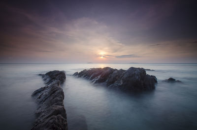 Scenic view of sea against sky at sunset