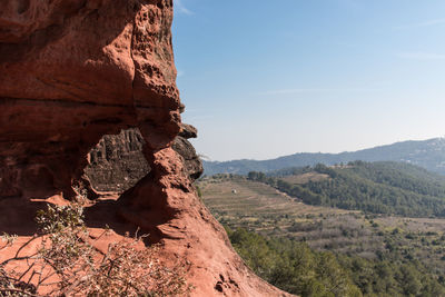 Rock formations on landscape against sky