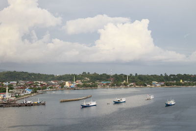 High angle view of sailboats moored in sea against sky