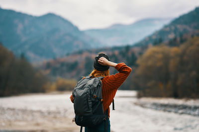 Rear view of man standing on mountain