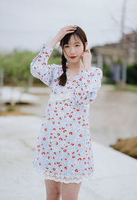 Portrait of young woman standing outdoors