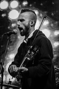 Man playing guitar at music concert