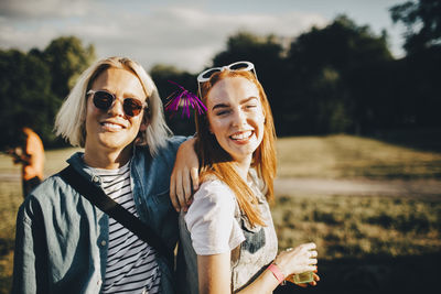 Portrait of smiling young woman wearing sunglasses