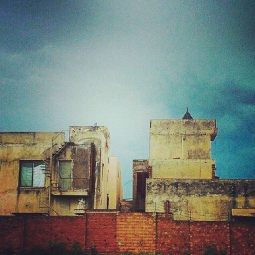 architecture, built structure, building exterior, low angle view, blue, sky, house, copy space, residential structure, window, building, clear sky, residential building, outdoors, wall - building feature, old, no people, day, high section, wall