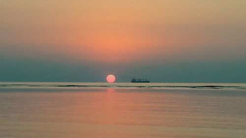 Scenic view of sea against sky at sunset