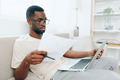 Midsection of man working on table