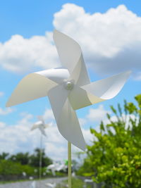 Close-up of white toy on field against sky