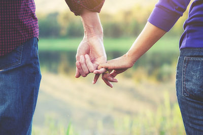 Close-up of couple holding hands