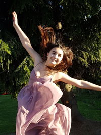 Portrait of young woman sitting outdoors