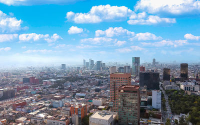 High angle view of buildings in city against sky