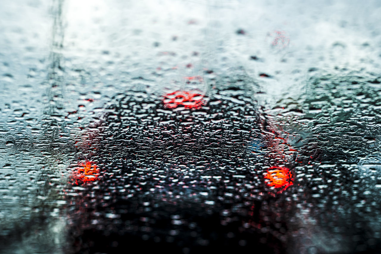 FULL FRAME SHOT OF WET GLASS WITH ROAD