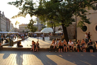 People on street in city against sky