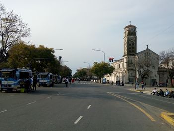 City street and buildings against sky