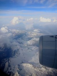 Aerial view of snowcapped landscape against sky