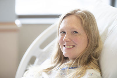 Portrait of a smiling young woman on bed