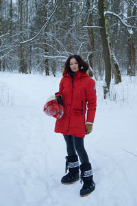 Full length of woman skiing on snow covered field