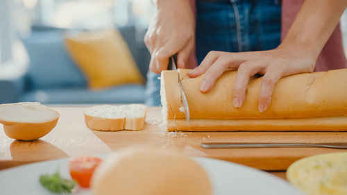 Midsection of woman preparing food on table