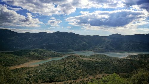 Scenic view of mountains against cloudy sky