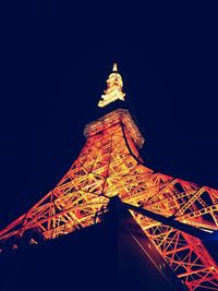 Low angle view of illuminated building against sky at night