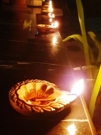 Close-up of lit candles on table