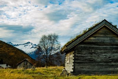 Built structure on field by building against sky