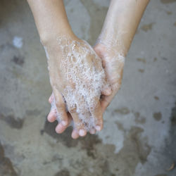 Low section of person on wet sand