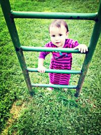 Girl playing on grassy field in park