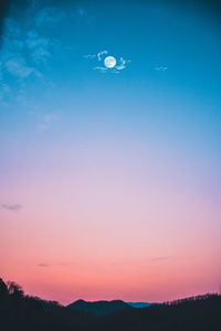 Low angle view of silhouette trees against sky at sunset