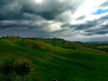 Scenic view of green landscape against sky
