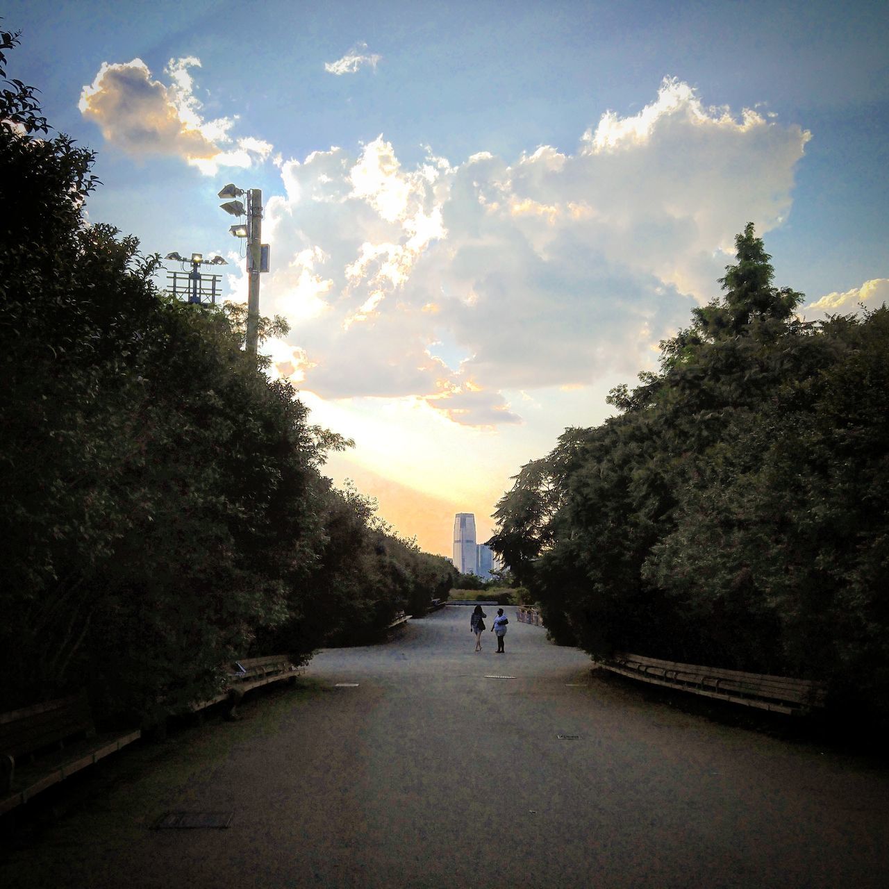 MAN WALKING BY ROAD