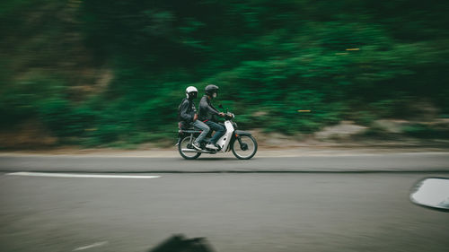 Man riding bicycle on road