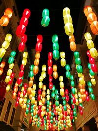 Low angle view of illuminated lanterns hanging against sky