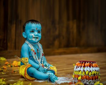 Baby boy wearing krishna costume looking away
