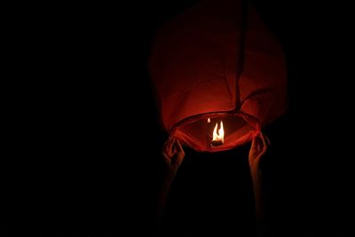 Close-up of illuminated lantern over black background