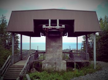 Lifeguard hut on land against sky