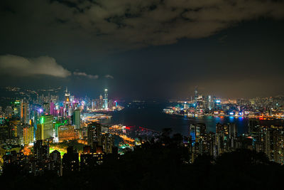 High angle view of illuminated buildings against sky at night