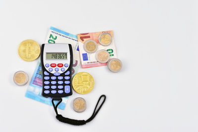 High angle view of coins on white background