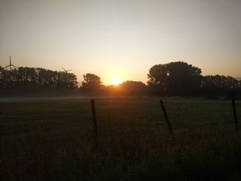 Scenic view of field against sky during sunset