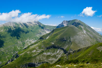 Scenic view of mountains against sky in montemonaco, marche 