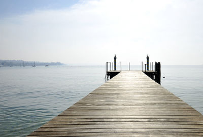 Pier over sea against sky