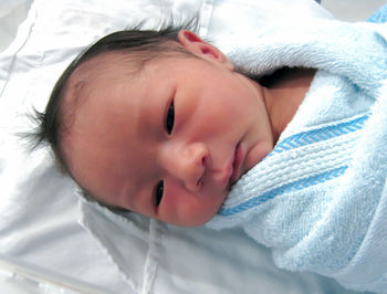 Close-up of baby boy sleeping on bed