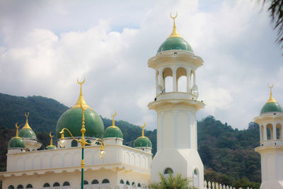 View of temple building against cloudy sky