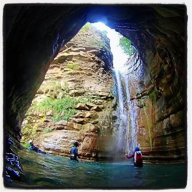 water, men, lifestyles, leisure activity, rock formation, rock - object, full length, person, tourist, transfer print, waterfall, travel, walking, motion, auto post production filter, tourism, rear view