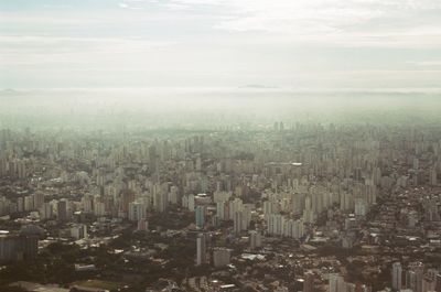 High angle view of city buildings against sky